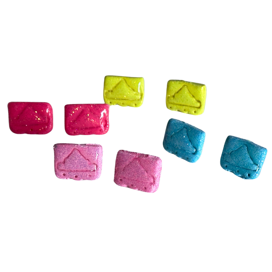 A variety of mini Alamo papel clay earrings made out of resin on a solid white background. Each earrings are zoomed in to show the variety of colors. Top row are yellow, second row are hot pink and sky blue, the third row are pink.