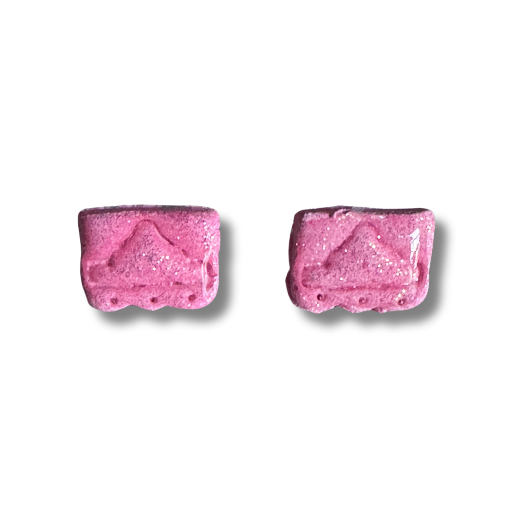 A zoomed in image of a pair of pink Alamo earring studs on a white background.