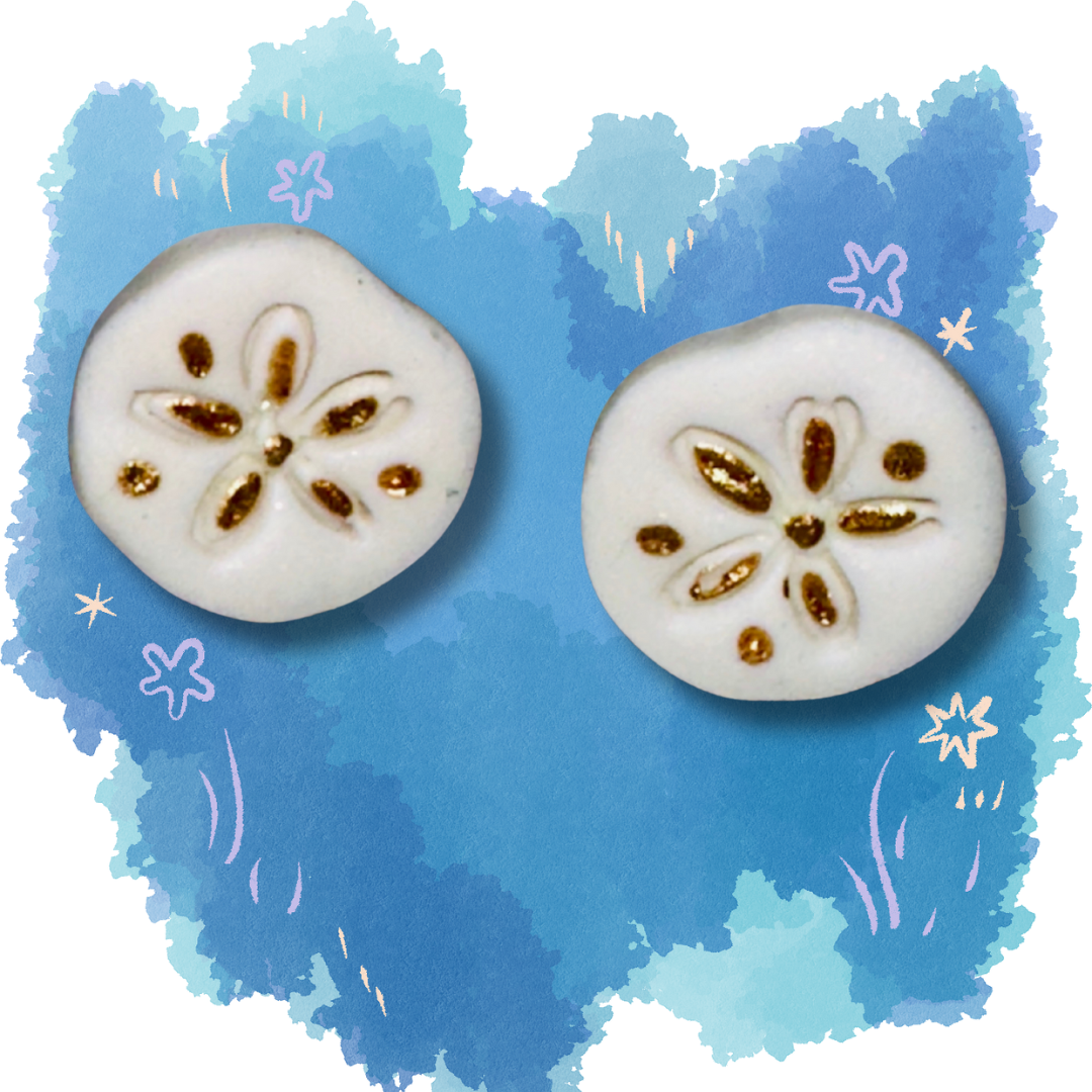 White sand dollar stud earrings made from polymer clay with nickel-free backing, displayed on a blue, ocean-themed background.