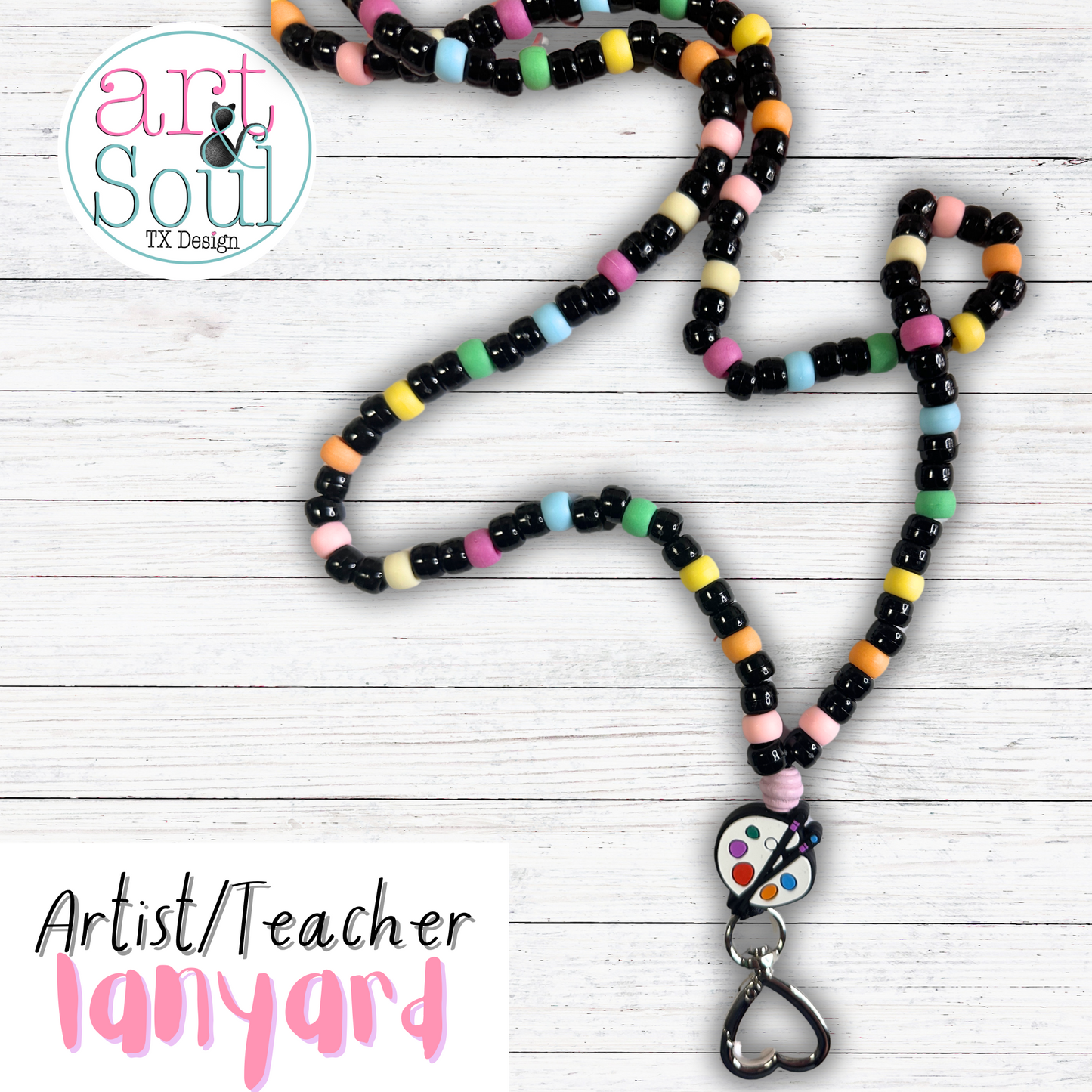 The artist/teacher lanyard on a white wooden background.