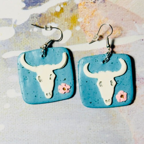 Georgia O'Keefe inspired skull style earrings with artistic design.
