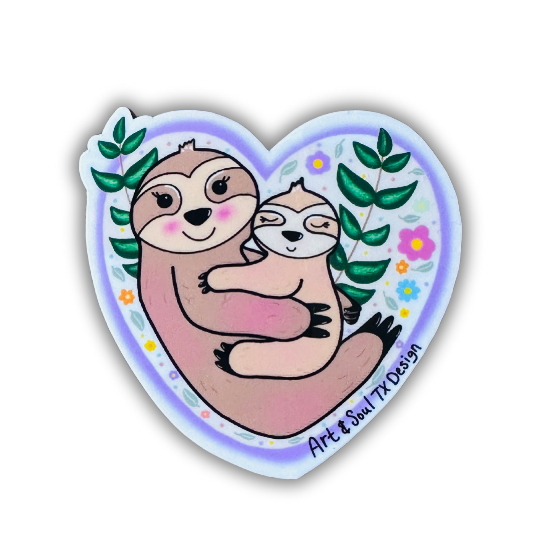 A heart shaped sticker with momma sloth holding her baby sloth. Behind them are branches of green leaves and colorful flowers, leaves, and dots as an embellishment. This sticker is on a white background.