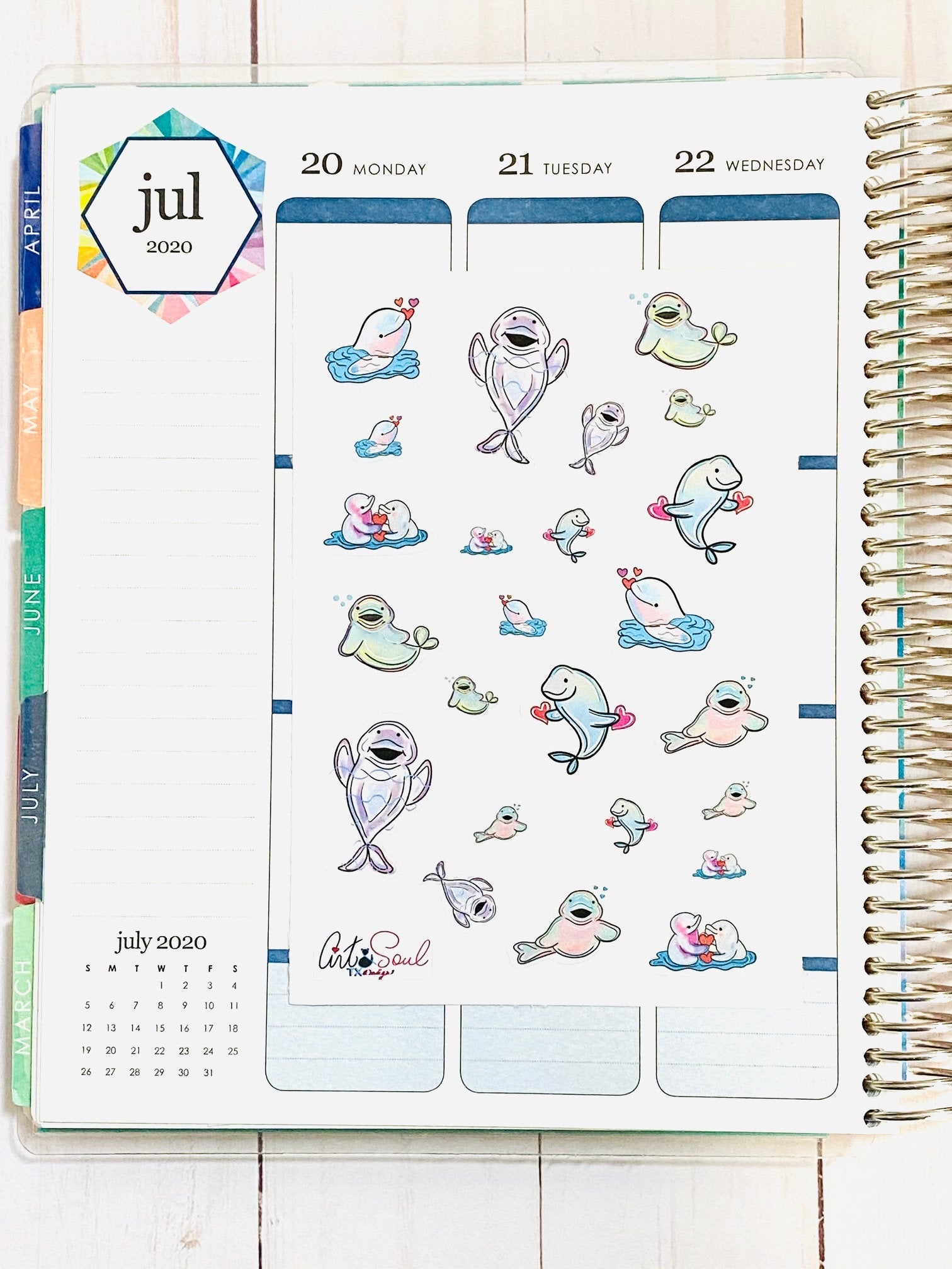 A sheet of Beluga Whale stickers in an Erin Condren planner.